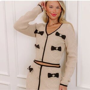 Elegant Beige and Black Bow-Accent Rhibestone embellished bow Sweater